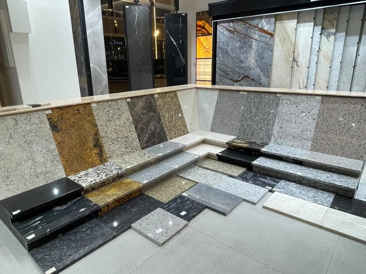 Granite stair-step display in the showroom, from black to speckled grey and gold
