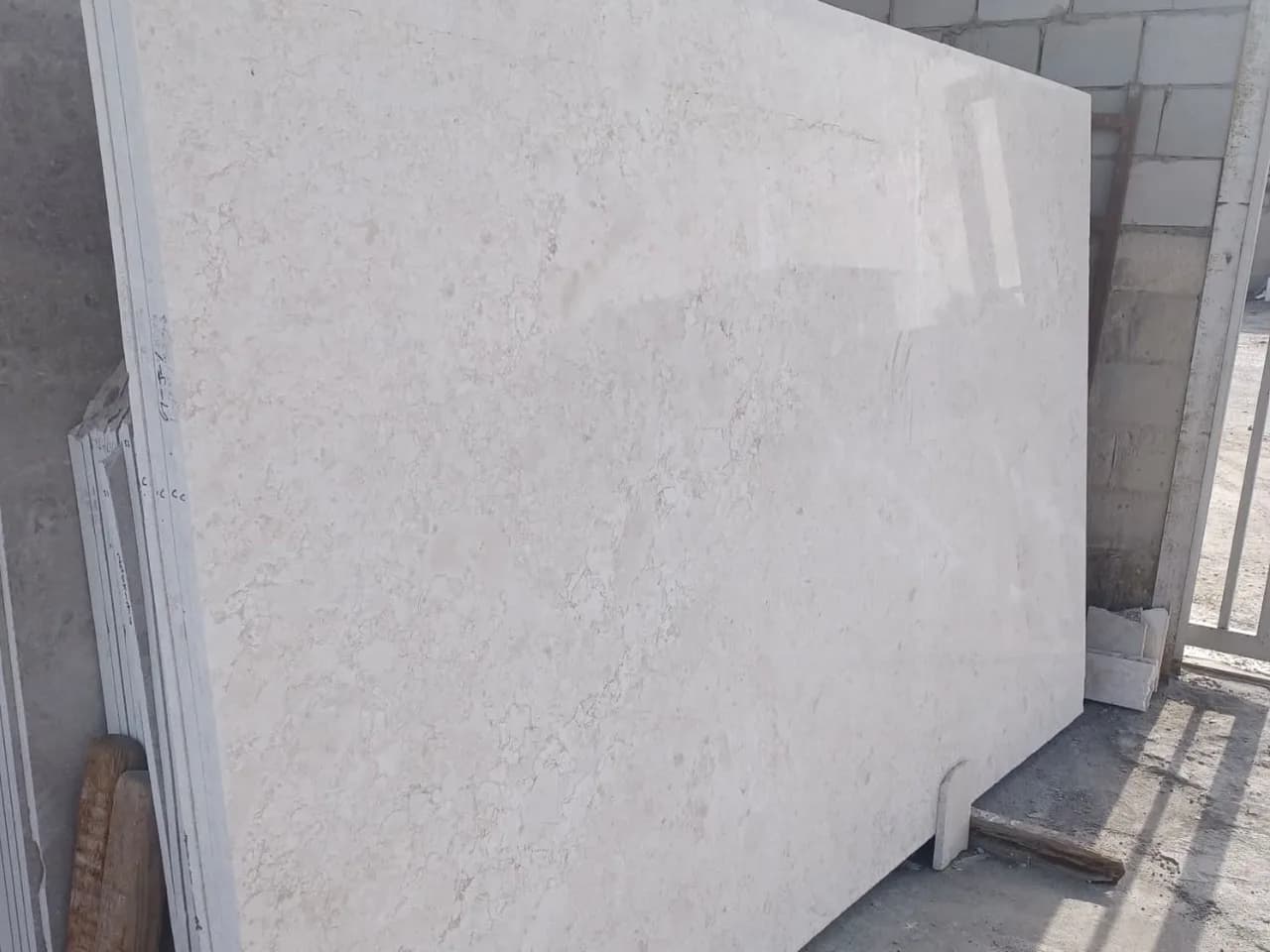 Slab of omani Light (Omani Fatah) marble, light beige with a fine even pattern, at the stone yard