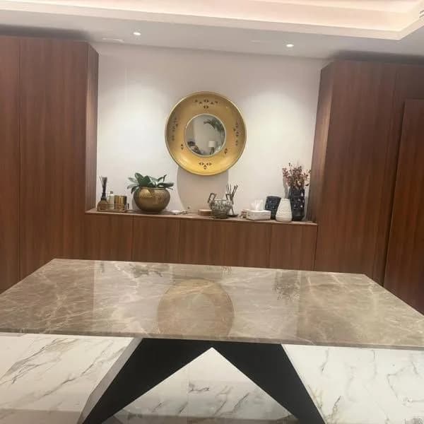 Marble table top on a black stand in a dining room