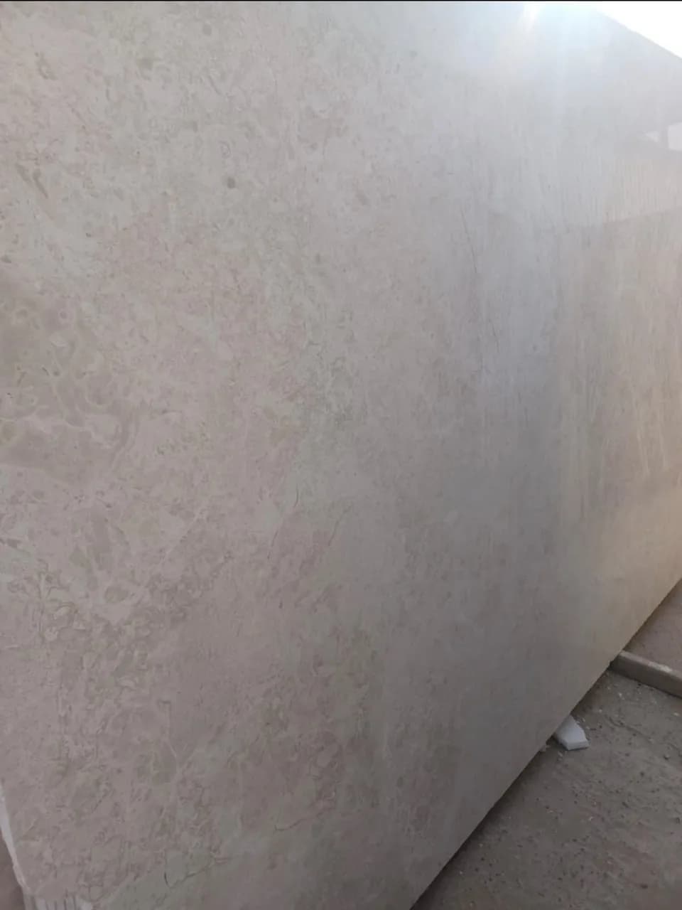 Close view of a beige Omani marble slab in the stone yard